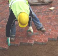 man laying paving blocks